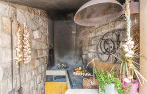 a room with a brick wall and a grill with plants at Nice Apartment In Makarska With 1 Bedrooms And Wifi in Makarska