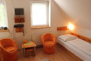 A bed or beds in a room at Penzión U Johna