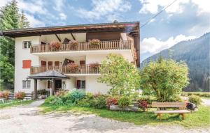 a building with a balcony and a bench at Residence Alessandra in Corvara in Badia