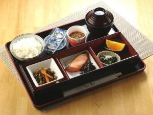 a tray of food with sushi and other food items at Shonandai Daiichi Hotel Fujisawa Yokohama in Fujisawa