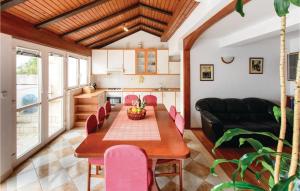 a kitchen and dining room with a table and chairs at Cozy Apartment In Dubrovnik With House Sea View in Dubrovnik