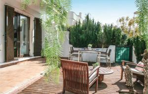 a patio with a table and chairs and plants at 3 Bedroom Nice Apartment In Alcossebre in Alcossebre