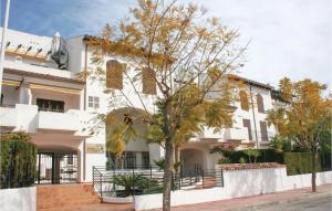 a white building with a tree in front of it at 3 Bedroom Nice Apartment In Alcossebre in Alcossebre