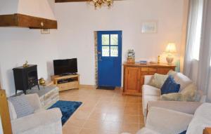 a living room with a blue door and a tv at Beautiful Home In Le Faout With Kitchen in Le Faouët