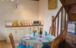 a kitchen with a table with a bottle of wine at Beautiful Home In Le Faout With Kitchen in Le Faouët