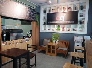 a restaurant with tables and chairs in a room at Double D Rooms & Cafe in Bangkok