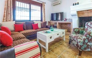 a living room with a couch and a fireplace at Stunning Home In El Gastor With 3 Bedrooms, Outdoor Swimming Pool And Swimming Pool in El Gastor