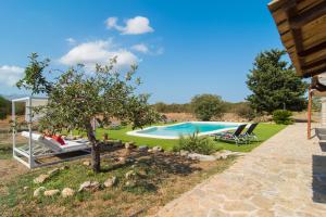 an image of a swimming pool in a garden at Finca Can Mel in Búger