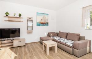 a living room with a couch and a tv at 6 Bedroom Stunning Home In Lukovo in Lukovo