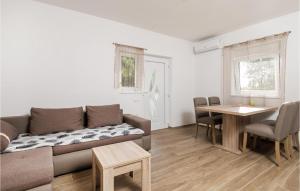 a living room with a couch and a table at 6 Bedroom Stunning Home In Lukovo in Lukovo