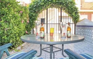 a table with bottles and glasses on a patio at Two-Bedroom Holiday Home In Los Alcazares in Los Alcázares
