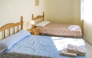 two twin beds in a room with a window at Two-Bedroom Holiday Home In Los Alcazares in Los Alcázares +5 photos
