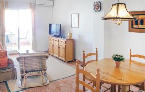 a living room with a wooden table and a television at Beautiful Apartment In Torrevieja With 2 Bedrooms And Internet in Torrevieja