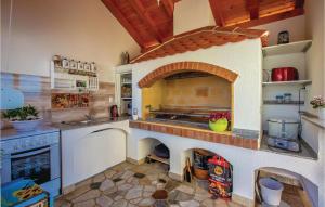 a kitchen with a large oven in the middle at Stunning Apartment In Crikvenica With Kitchen in Crikvenica