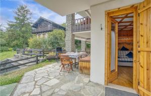 a patio with a table and chairs and a balcony at Cozy Apartment In Ayas With Kitchenette in Champoluc