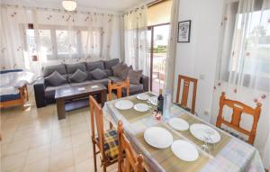 a living room with a table and a couch at Cozy Apartment In Roquetas De Mar With House Sea View in Roquetas de Mar