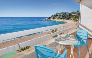a table and chairs on a balcony with a view of the beach at Stunning Apartment In Lloret De Mar in Lloret de Mar