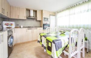 a kitchen with a table and chairs in a room at Villa Carolina Peñíscola in Peñíscola