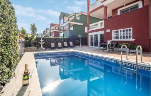 a swimming pool in front of a building at Villa Carolina Peñíscola in Peñíscola