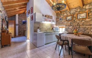 a kitchen and dining room with a table and a stove at Pet Friendly Home In Ledenice With Kitchen in Ledenice