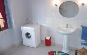 a bathroom with a washing machine and a sink at Nice Home In Val-de-louvre-et-caude With House A Panoramic View in Saint-Alvère