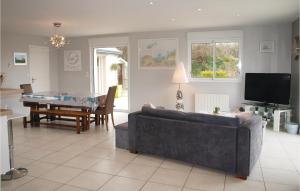 a living room with a couch and a table at Holiday Home Rue Sainte-Anne in Trélévern