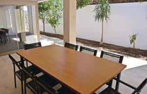 a wooden table and chairs in a room with trees at Es Molinar in Palma de Mallorca