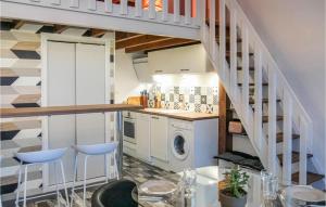 a kitchen with a staircase and a washing machine at Maison 4 in Montmartin-sur-Mer