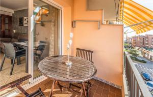 a wooden table on a balcony with a table at Gorgeous Apartment In Pineda De Mar in Pineda de Mar +8 photos