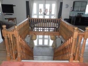 a wooden spiral staircase in a living room at Country House Ashdene in Highworth