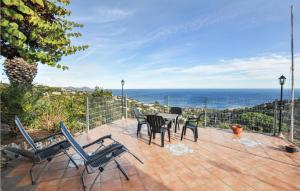 a patio with a table and chairs and the ocean at Lovely Home In Roquebrune-sur-argens With Kitchen in Saint-Peïre-sur-Mer
