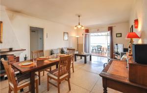 a living room with a wooden table and chairs at Awesome Home In Roquebrune-Sur-Argens in Saint-Peïre-sur-Mer