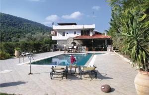 a villa with a swimming pool and a house at Nice Home In Agia Marina Aigina With Kitchen in Agia Marina Aegina