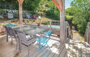 a glass table and chairs on a wooden deck at Beautiful Home In Bordezac in Bordezac