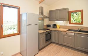 a kitchen with a refrigerator and a sink at Beautiful Home In Bordezac in Bordezac +25 photos