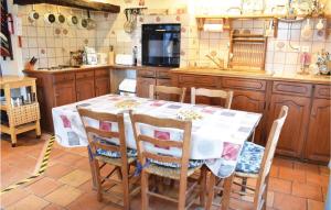 a kitchen with a table and chairs in a kitchen at 4 Bedroom Beautiful Home In Bosroumois in Bosnormand +14 photos