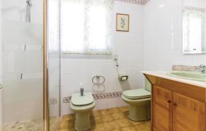 a bathroom with a toilet and a sink and a shower at 2 Bedroom Cozy Home In Faro De Cullera in Faro de Cullera +13 photos