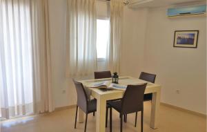 a dining room with a table and chairs and a window at Hacienda Riquelme in Sucina