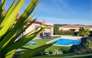 a villa with a swimming pool and a house at 3 Bedroom Nice Home In Quarante in Quarante