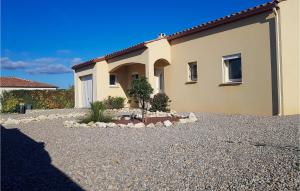 a house with a gravel driveway in front of it at 3 Bedroom Nice Home In Quarante in Quarante