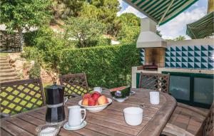 a wooden table with a bowl of fruit on it at Nice Home In Sant Feliu De Guíxols in Sant Feliu de Guixols