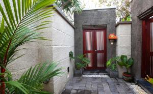 a red door on the side of a house at The Bali Bliss Villa in Seminyak