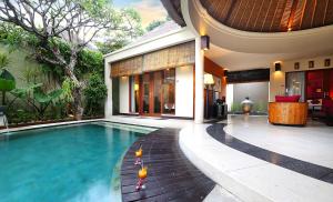 a house with a swimming pool in front of a house at The Bali Bliss Villa in Seminyak +20 photos