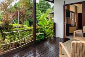 a wood decked patio with a view of the ocean at Fisherman's Cove Resort in Beau Vallon