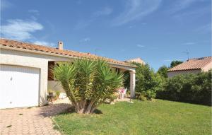 un palmier dans une cour à côté d'une maison dans l'établissement Beautiful Home In Pignan With 3 Bedrooms, à Pignan