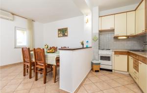 a kitchen with a table and chairs in it at 2 Bedroom Nice Apartment In Potocnica in Potocnica