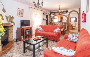a living room with red couches and a tv at Stunning Home In Torrox With House A Mountain View in Torrox