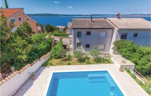 an aerial view of a house with a swimming pool at Amazing Home In Crikvenica With 4 Bedrooms, Wifi And Outdoor Swimming Pool in Dramalj