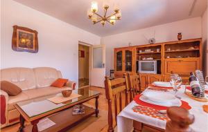 a living room with a couch and a table at Amazing Home In Crikvenica With 4 Bedrooms, Wifi And Outdoor Swimming Pool in Dramalj