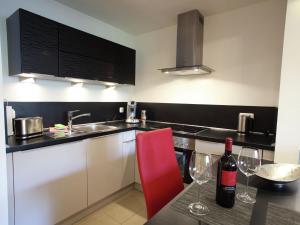 A kitchen or kitchenette at Stylish apartment with indoor pool and infrared sauna in the Bavarian Forest